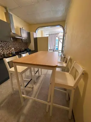 a kitchen with a wooden table and chairs at Appartement à Bruxelles Midi - Grand place Bruxelles in Brussels