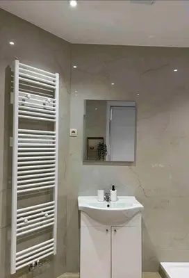 a bathroom with a white sink and a mirror at Sublime appartement Calme Cosy & Jacuzzi in Brussels