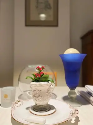 a table with a vase with a plant on it at The Doors City Park House in Ghent