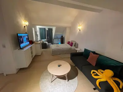 a living room with a couch and a table at The Doors City Park House in Ghent