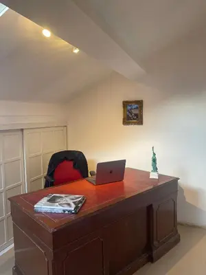a desk with a laptop computer on top of it at The Doors City Park House in Ghent