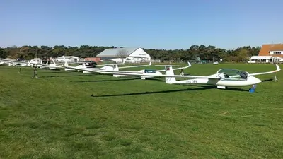 a row of small airplanes sitting on a field at Imagine Tiny House 325 op Camping GT te Balen in Balen