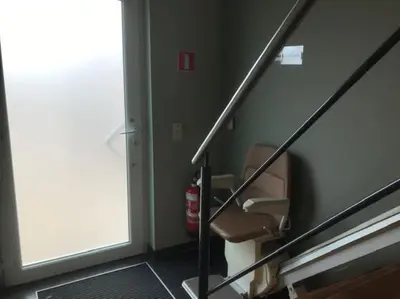 a stair case with a chair in a room at Fokus Time out in Dessel