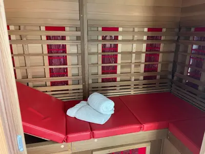 a red bench with a white towel on it at Fokus Time out in Dessel