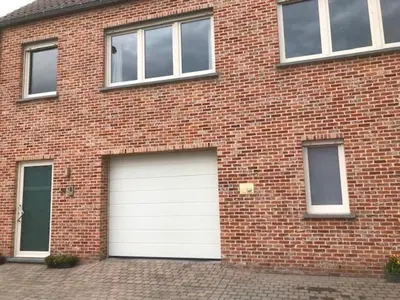 a brick building with two garage doors on it at Fokus Time out in Dessel