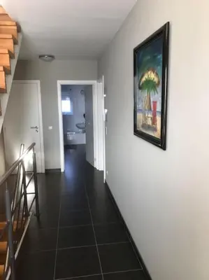 a hallway with a painting on a white wall at Fokus Time out in Dessel
