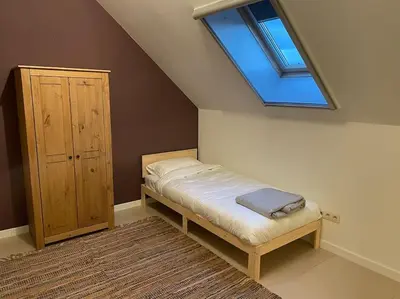 a bedroom with a bed and a skylight at Wilgentuin in Bekkevoort