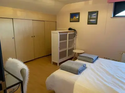 a bedroom with a bed with two pillows on it at Wilgentuin in Bekkevoort