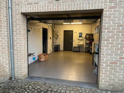 a large room with a brick wall and a doorway at Wilgentuin in Bekkevoort