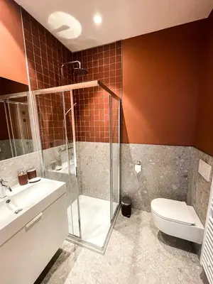 a bathroom with a shower and a toilet and a sink at Maison d’Arnaud in Ghent
