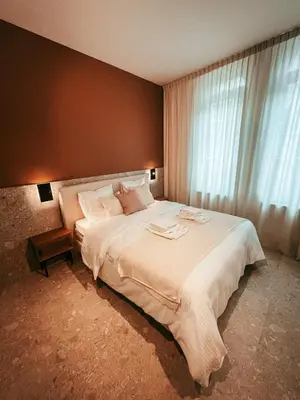 a bedroom with a large bed and a window at Maison d’Arnaud in Ghent