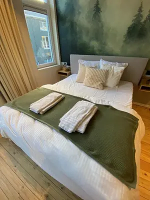 a bedroom with a bed with two towels on it at Maison d’Arnaud in Ghent