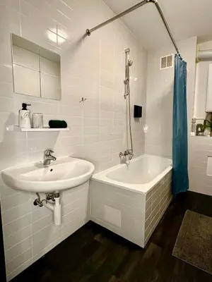 a white bathroom with a sink and a tub at Luxury Suites Stay by Rikas Hotels in Antwerp