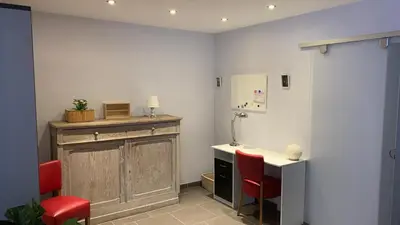 a room with a table and two red chairs at Ruime studio in Deurne in Antwerp