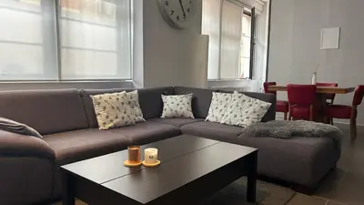 a living room with a couch and a coffee table at Ruime studio in Deurne in Antwerp