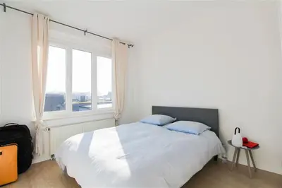 a bedroom with a large bed and a window at Plein centre de Waterloo! 2 in Waterloo