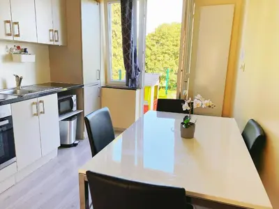 a kitchen with a white table with chairs and a window at Sweet home with big terrace in Brussels
