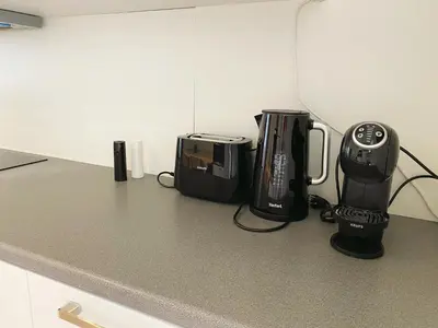 a kitchen counter with two coffins and a coffee maker at Sweet home with big terrace in Brussels