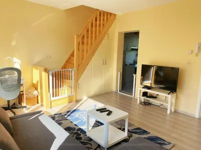 a living room with a couch and a tv at Sweet home with big terrace in Brussels