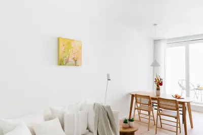 a white living room with a white couch and a table at High-end flats at South area in Antwerp