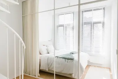 a bedroom with a mirror in front of a bed at High-end flats at South area in Antwerp