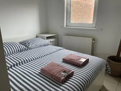 two beds with towels on them in a bedroom at Private studio in Antwerp in Antwerp