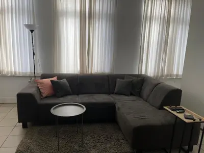 a living room with a couch and a table at Private studio in Antwerp in Antwerp