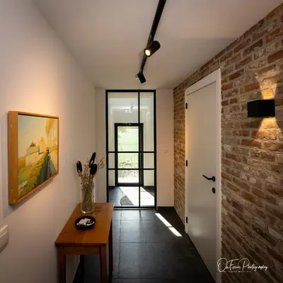 a room with a table and a brick wall at Vakantiehuis Paula in Watervliet