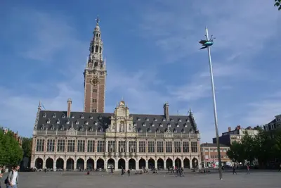 a large building with a clock tower on top of it at Guest House Feliz in Leuven