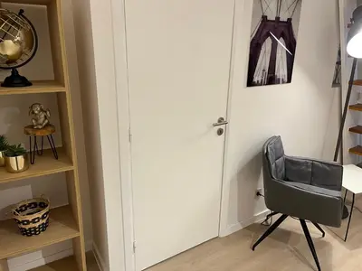 a room with a chair next to a door at Brussels center flat in Brussels