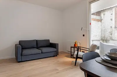 a living room with a couch and a table at Märch - Mechelen Goat 21 in Mechelen