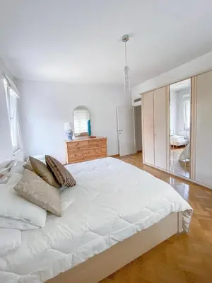 a white bedroom with a large white bed with pillows at Elegance ,Space & Luxury in Brussels in Brussels