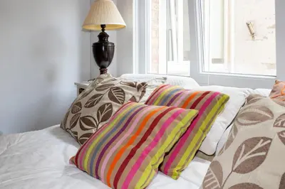 a white couch with two colorful pillows on it at Elegance ,Space & Luxury in Brussels in Brussels