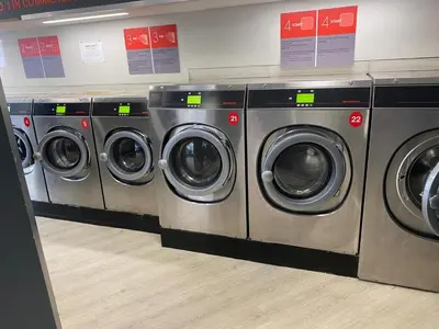 a row of washing machines in a laundry room at appartement douvres in Brussels