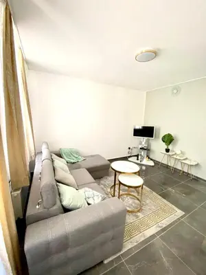 a living room with a couch and a table at appartement douvres in Brussels
