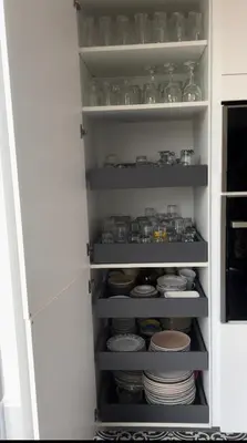 a white cabinet filled with plates and bowls at Appartement 3 chambres Centre Vilvoorde Bruxelles BrusselsAirport Expo NATO Anvers Wifi Free Parking in Vilvoorde