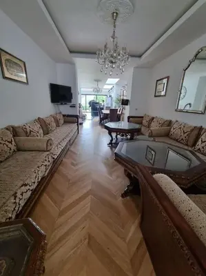 a living room with a couch and a table in it at Appartement 3 chambres Centre Vilvoorde Bruxelles BrusselsAirport Expo NATO Anvers Wifi Free Parking in Vilvoorde
