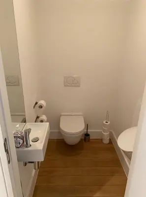 a bathroom with a white toilet and a sink at Business Accommodation Luxury Loft in Geel
