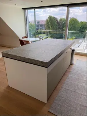 a kitchen with a counter top with a large window at Business Accommodation Luxury Loft in Geel