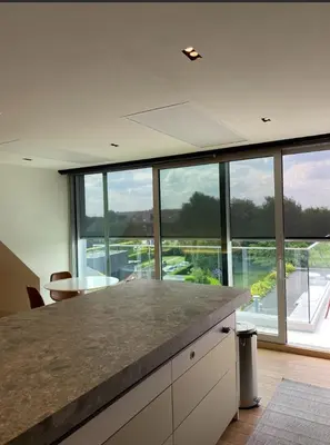 a kitchen with a counter with a large window at Business Accommodation Luxury Loft in Geel