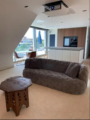 a living room with a couch and a table at Business Accommodation Luxury Loft in Geel
