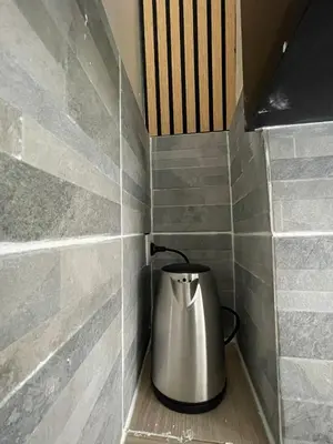 a tea kettle sitting in a corner of a wall at cantillonn in Brussels