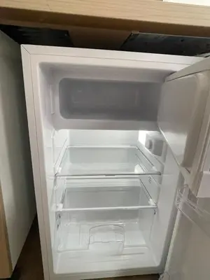 an empty white refrigerator with its door open at cantillonn in Brussels