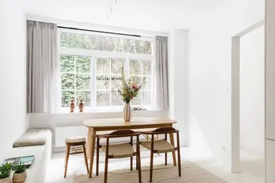 a dining room with a table and chairs and a window at High-end 3BDR apartment @ city center in Antwerp