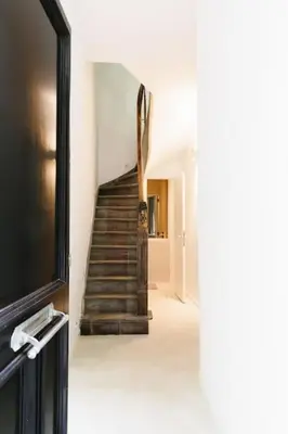 a hallway with a staircase in a house at High-end 3BDR apartment @ city center in Antwerp