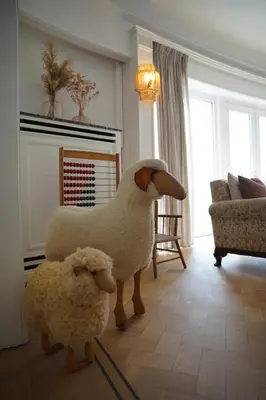 two stuffed sheep standing in a living room at Edville Home in Ghent