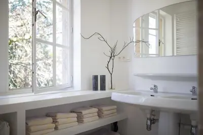 a white bathroom with a sink and a window at Edville Home in Ghent