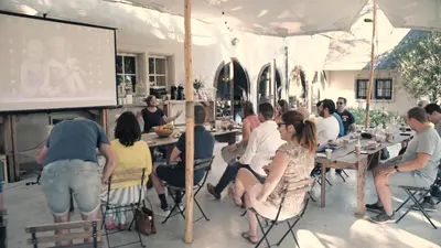 a group of people sitting at tables in a room at Edville Home in Ghent