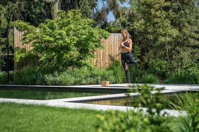 a woman standing on the edge of a swimming pool at Edville Home in Ghent