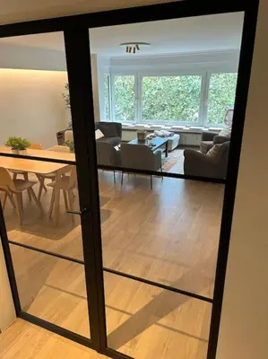a living room with a table and a dining room at Ghent by the water in Ghent